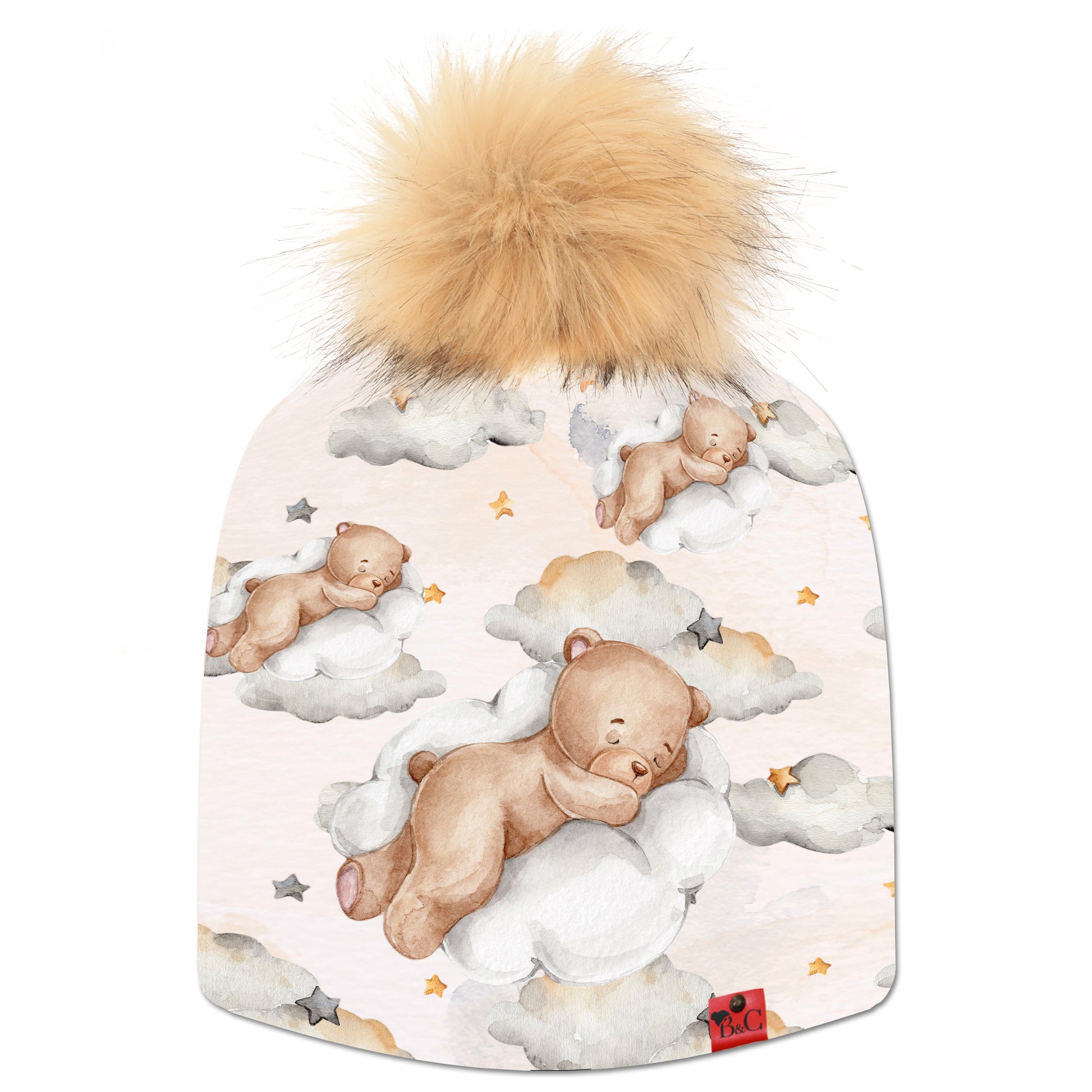 Bonnet Charlie pour enfants, avec un  motif d'ourson qui dort sur un nuage étoilé, accompagné de son pompon Loutre en fourrure synthétique et son étiquette en cuir signé Beanie and Clyde.