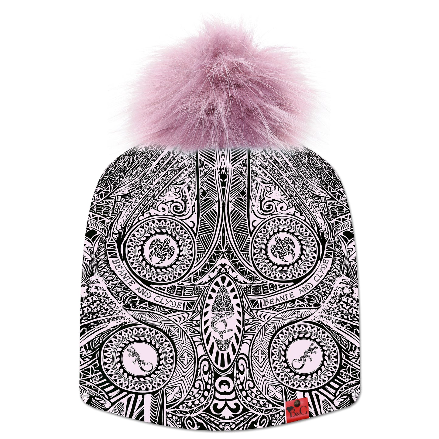 Bonnet Moana pour hommes et femmes, décoré de motifs d’inspiration maorie et polynésienne en rose pâle et noir. Il est surmonté d’un pompon Pourpre en fourrure synthétique, et orné de la signature en cuir rouge de Beanie & Clyde.