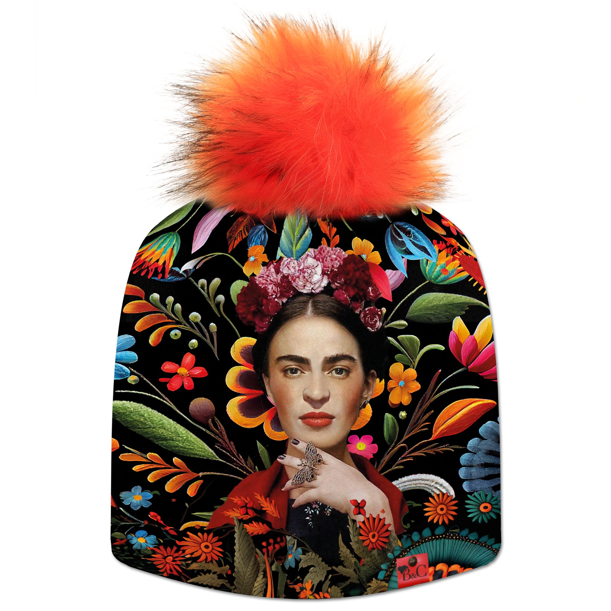 Bonnet Frida pour enfants, avec motif Frida Kahlo sur un fond fleuri très coloré et accompagné de son pompon Renard en fourrure synthétique et son étiquette en cuir rouge signée Beanie and Clyde.