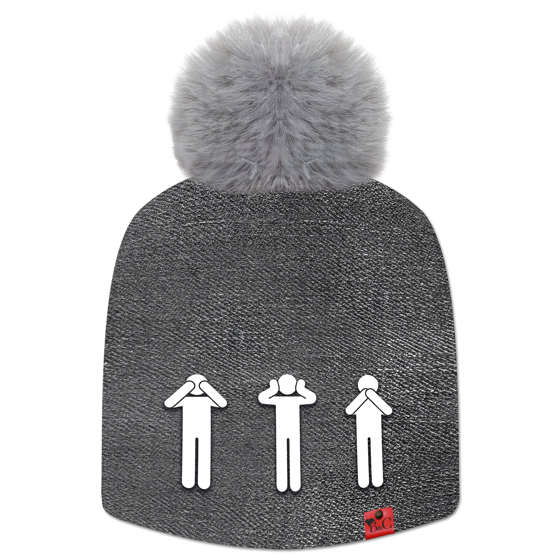 Bonnet Yoko pour enfants, habillé d’un motif effet jean noir délavé, surmonté d’un pompon gris en fourrure synthétique. Il est orné de l’étiquette en cuir rouge signée Beanie & Clyde, avec au premier plan trois pictogrammes représentant les singes de la sagesse : ne rien voir, ne rien entendre, ne rien dire.